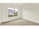 Empty bedroom boasting neutral walls, carpet and a bright window view at 7168 Jackson Dr, Cumberland, IN 46229