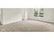 Bright bedroom with natural light from a window and neutral carpet at 7168 Jackson Dr, Cumberland, IN 46229