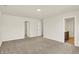 Bedroom features soft carpet, neutral walls, and access to bathroom at 7168 Jackson Dr, Cumberland, IN 46229