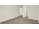 Comfortable bedroom showcasing soft carpet and access to closet space at 7168 Jackson Dr, Cumberland, IN 46229