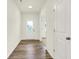 Bright entryway featuring hardwood floors, neutral walls, and a sun tunnel skylight at 7168 Jackson Dr, Cumberland, IN 46229