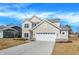 Beautiful home featuring a well-manicured lawn, concrete driveway, and a two-car garage at 7168 Jackson Dr, Cumberland, IN 46229