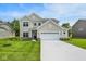Charming two-story home with a manicured lawn, two-car garage, and inviting curb appeal at 7168 Jackson Dr, Cumberland, IN 46229