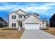 Charming two-story home featuring a two-car garage, stone accents, and a well-manicured lawn at 7168 Jackson Dr, Cumberland, IN 46229