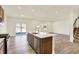 Open-concept kitchen featuring a center island with stainless-steel appliances and ample counter space at 7168 Jackson Dr, Cumberland, IN 46229