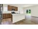 Well-lit kitchen with an island, stainless steel appliances, and sliding glass doors at 7168 Jackson Dr, Cumberland, IN 46229