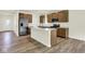 Modern kitchen featuring an island, stainless steel appliances, and wooden cabinetry at 7168 Jackson Dr, Cumberland, IN 46229