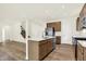 Spacious kitchen featuring a kitchen island, stainless steel appliances, and open floor plan at 7168 Jackson Dr, Cumberland, IN 46229