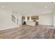 Bright open-concept living room and kitchen area with modern flooring and ample natural light at 7168 Jackson Dr, Cumberland, IN 46229