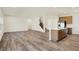 Spacious living area with open kitchen, wood floors, and modern lighting at 7168 Jackson Dr, Cumberland, IN 46229