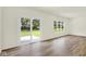 Bright living room with sliding glass doors and a large window, showcasing natural light at 7168 Jackson Dr, Cumberland, IN 46229