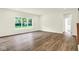 Open living room featuring hardwood flooring, neutral walls, and natural light at 7168 Jackson Dr, Cumberland, IN 46229