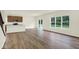 Bright and airy living room featuring a large window, wood flooring, and sliding glass doors at 7168 Jackson Dr, Cumberland, IN 46229