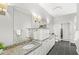 Stylish bathroom showcasing a granite countertop vanity with ample cabinet space and contemporary lighting fixtures at 720 S Rangeline Rd # 703, Carmel, IN 46032