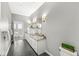 Elegant bathroom featuring double vanity with granite countertop, modern fixtures, and a glimpse into the bedroom at 720 S Rangeline Rd # 703, Carmel, IN 46032