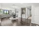 Bright dining area with dark wood floors, a round table, and a view of the balcony at 720 S Rangeline Rd # 703, Carmel, IN 46032