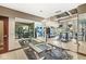 Bright and spacious gym featuring diverse exercise equipment, large mirrors, and ample natural light for an invigorating workout at 720 S Rangeline Rd # 703, Carmel, IN 46032
