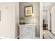 Hallway featuring a decorative cabinet with a lamp, art, and a view to a carpeted hallway at 720 S Rangeline Rd # 703, Carmel, IN 46032
