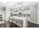 Modern kitchen with white cabinets, a center island, and stainless-steel appliances at 720 S Rangeline Rd # 703, Carmel, IN 46032