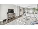 Living room view with modern décor and open layout leading to the dining area and entry at 720 S Rangeline Rd # 703, Carmel, IN 46032