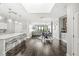 Open-concept living space with hardwood floors, a kitchen island, and a dining area at 720 S Rangeline Rd # 703, Carmel, IN 46032
