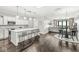 Open-concept living space with hardwood floors, a kitchen island, and a dining area at 720 S Rangeline Rd # 703, Carmel, IN 46032