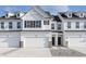 Charming townhouse featuring a clean white exterior, black shutters, and a one car garage at 7324 Shroyer Way, Noblesville, IN 46062