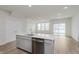 Bright kitchen with a center island, stainless steel appliances, and wood-look flooring at 7324 Shroyer Way, Noblesville, IN 46062