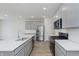 Contemporary kitchen features stainless steel appliances, gray cabinets, and a large island at 7324 Shroyer Way, Noblesville, IN 46062