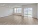 Open living room with natural light from windows and sliding doors, plus wood-look flooring at 7324 Shroyer Way, Noblesville, IN 46062