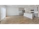 Spacious living room with wood-look flooring, connecting to the kitchen with stainless appliances at 7324 Shroyer Way, Noblesville, IN 46062