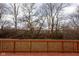 View of wooden deck overlooking the backyard's serene trees and a quiet landscape at 7332 Jackie Ct, Indianapolis, IN 46221