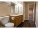 Bathroom featuring toilet, vanity with sink, wood-look flooring and open doorway at 7332 Jackie Ct, Indianapolis, IN 46221