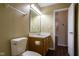 Cozy bathroom featuring hard surface floors, a toilet, sink and a vanity with a large mirror at 7332 Jackie Ct, Indianapolis, IN 46221