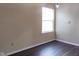 Bright bedroom featuring wood floors, a window with natural light and neutral colored walls at 7332 Jackie Ct, Indianapolis, IN 46221