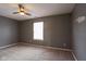Neutral bedroom featuring plush carpeting, a window letting in natural light, and a ceiling fan at 7332 Jackie Ct, Indianapolis, IN 46221