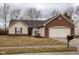 Charming single-story home featuring brick and vinyl siding with an attached two-car garage at 7332 Jackie Ct, Indianapolis, IN 46221