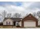 Charming single-story home featuring brick and vinyl siding with an attached two-car garage at 7332 Jackie Ct, Indianapolis, IN 46221