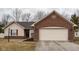 Charming single-story home featuring brick and vinyl siding with an attached two-car garage at 7332 Jackie Ct, Indianapolis, IN 46221