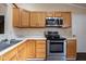 Kitchen with oak cabinets, white countertops, and stainless steel appliances at 7332 Jackie Ct, Indianapolis, IN 46221