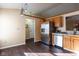 Well-lit kitchen featuring stainless steel appliances, wood cabinets, and durable hardwood floors at 7332 Jackie Ct, Indianapolis, IN 46221