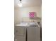 Bright laundry room featuring new washer and dryer along with functional wire shelving at 7332 Jackie Ct, Indianapolis, IN 46221