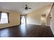 Spacious living room featuring dark wood floors, ceiling fan, and sliding glass doors at 7332 Jackie Ct, Indianapolis, IN 46221