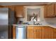 Kitchen sink with oak cabinets, white countertops, and stainless steel appliances at 7332 Jackie Ct, Indianapolis, IN 46221
