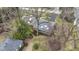 An aerial view of a home with mature trees, green grass, and a detached garage at 7481 Holliday E Dr, Indianapolis, IN 46260