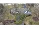 An aerial view of the home shows a well manicured lawn, mature trees, and brick exterior at 7481 Holliday E Dr, Indianapolis, IN 46260
