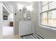 Bathroom vanity featuring drawers, cabinets, and a window at 7481 Holliday E Dr, Indianapolis, IN 46260