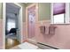 A bathroom with a glass-doored shower, tile flooring and vintage pink walls at 7481 Holliday E Dr, Indianapolis, IN 46260