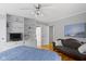 A well-lit bedroom with hardwood flooring, and comfortable furnishings and decor at 7481 Holliday E Dr, Indianapolis, IN 46260