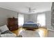 Cozy bedroom with hardwood floors, a ceiling fan, a large bed and natural light at 7481 Holliday E Dr, Indianapolis, IN 46260